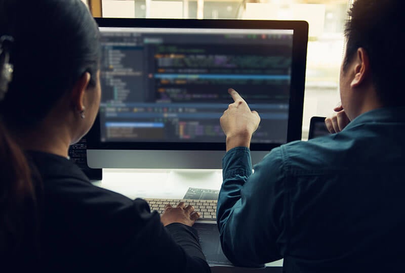 man pointing at monitor