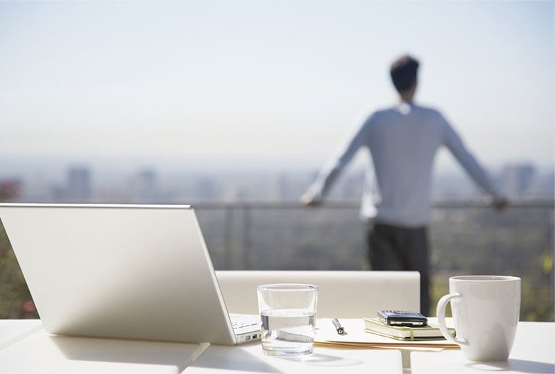 person working on a rooftop patio