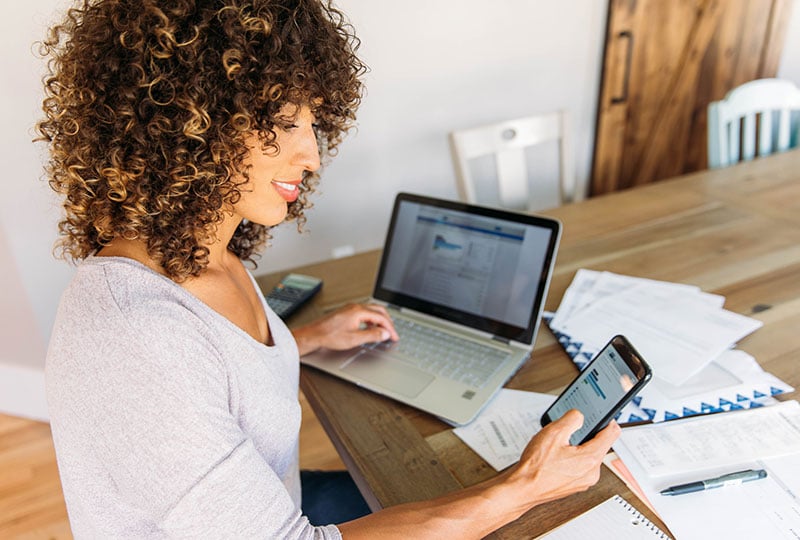 woman working and looking at phone