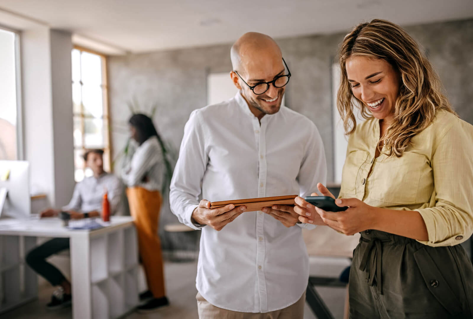 two people looking at mobile devices