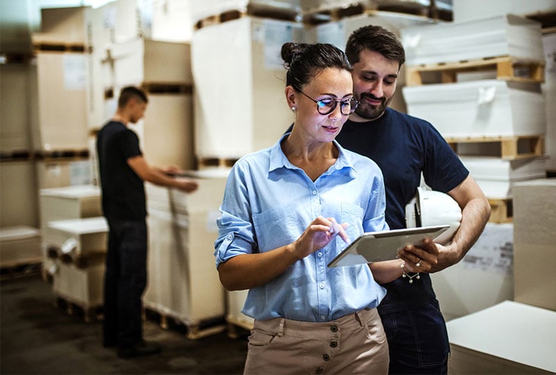 Woman and man interacting with a tablet computer.