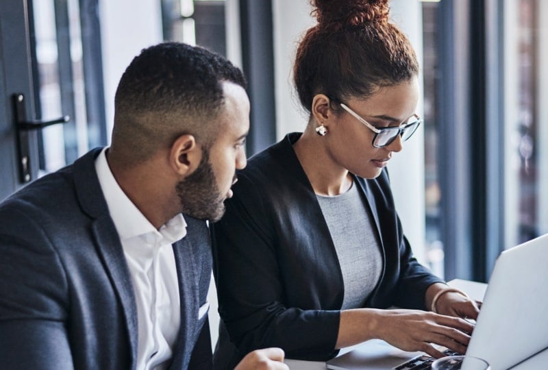 two people working at a laptop
