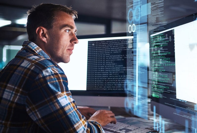 a man looking at computer screens