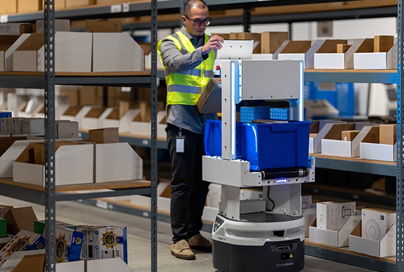 Worker interacting with an AMR.